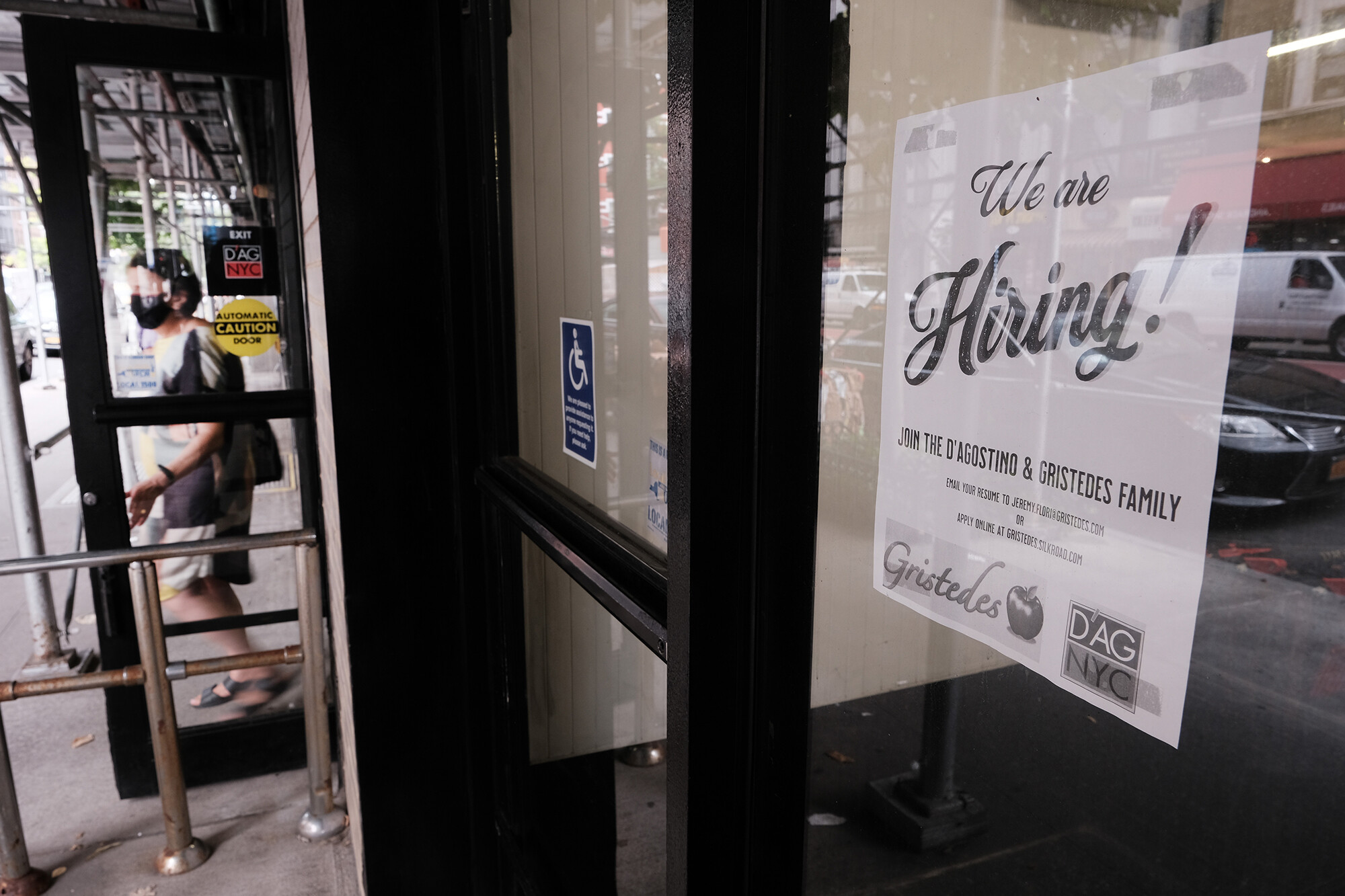 <i>Spencer Platt/Getty Images</i><br/>The number of first-time claims for jobless benefits dipped to a new pandemic-era low last week. A hiring sign is displayed in a store window in Manhattan on August 19
