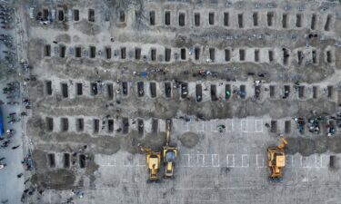 Mourners dig graves on Tuesday for those killed in a February 28 strike on the Shajare Tayyiba elementary school in Minab